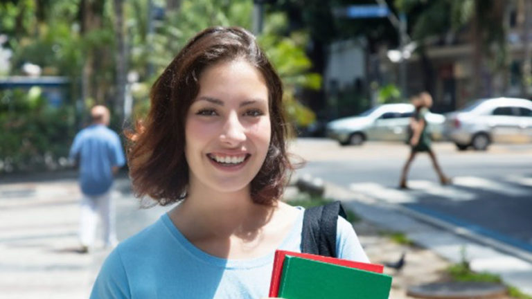 Student smiling on the street