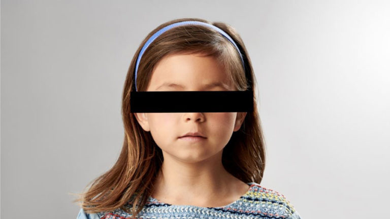 young girl with black bar over eyes